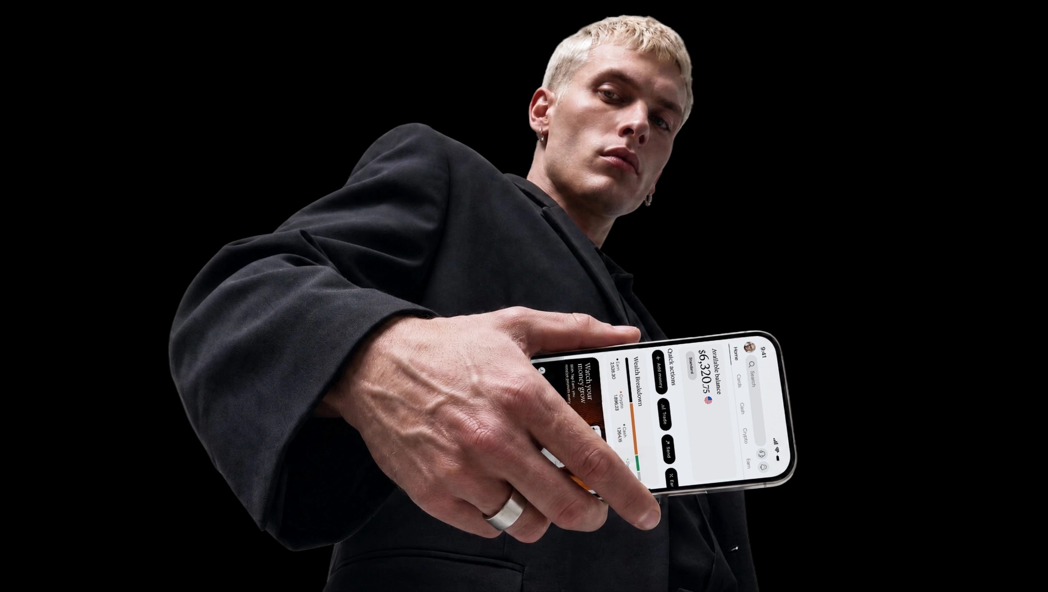 Person holding a smartphone showing the Tap app balance and wealth breakdown