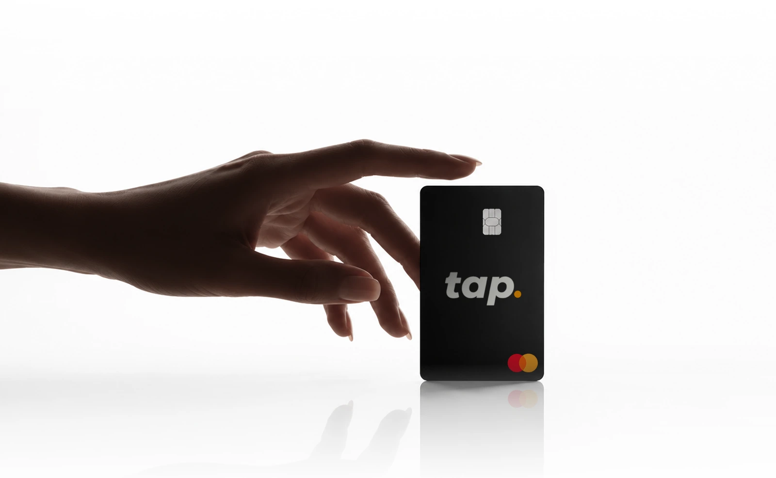 Hand reaching toward a matte black Tap Mastercard